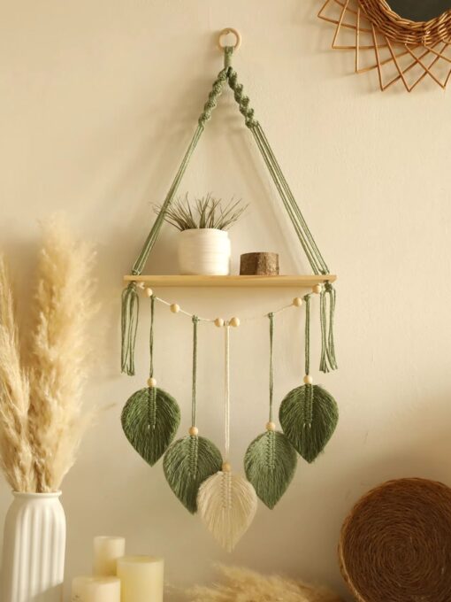 Wall shelf with green macramé leaves